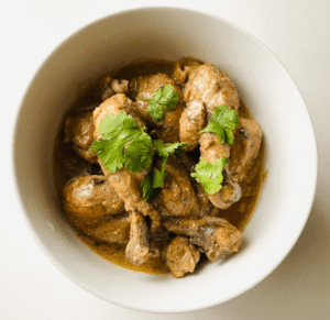 Easy chicken curry cooking in a pan with rich, thick gravy